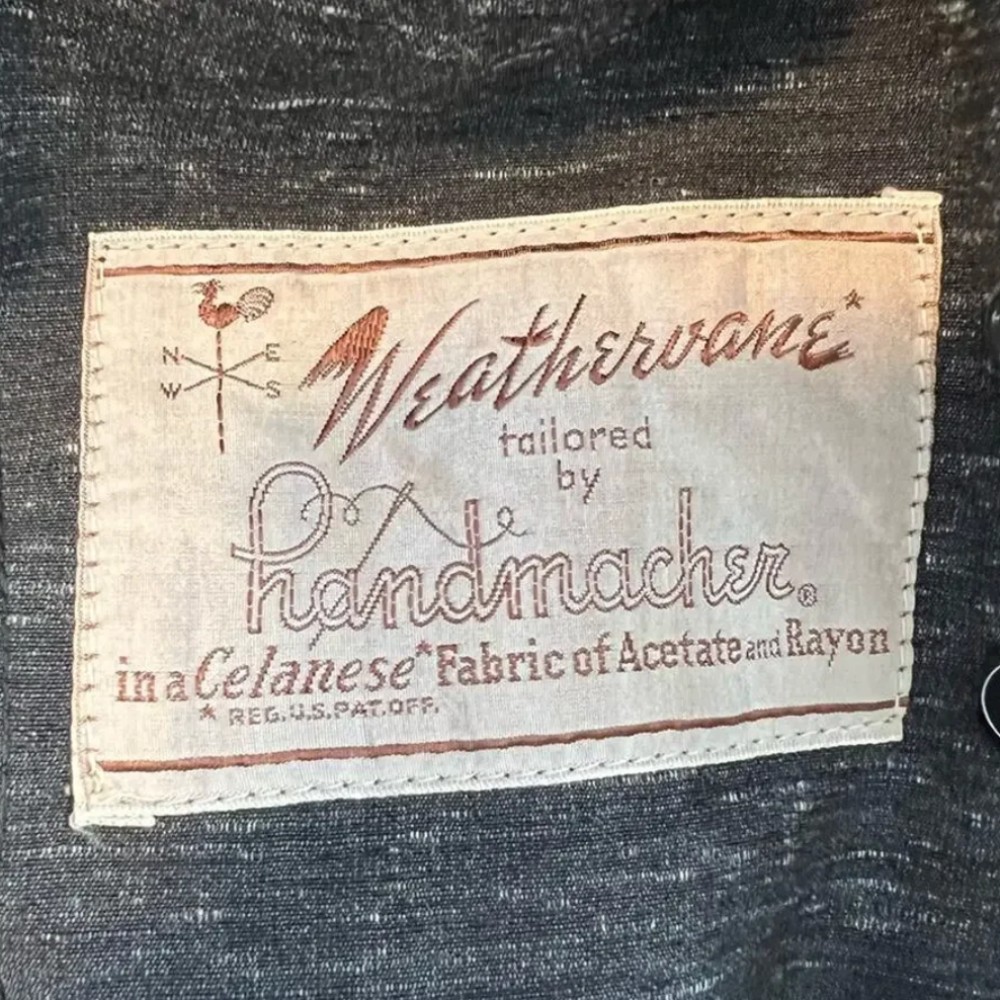 Weathervane clothing tag. Approximate date: 1950s. Recorded notes: Brand- Weathervane, By Manufacturer Handmacher-Vogel, Inc. Weathervane was a popular women's tailored suit collection produced by Handmacher-Vogel, Inc. during the mid-20th century.