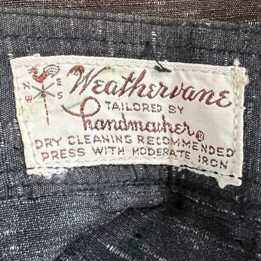Weathervane clothing tag. Approximate date: 1950s. Recorded notes: Brand- Weathervane, By Manufacturer Handmacher-Vogel, Inc. Weathervane was a popular women's tailored suit collection produced by Handmacher-Vogel, Inc. during the mid-20th century.